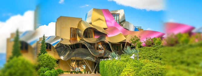 Trip Serbien Reisetipps - Marqués de Riscal Design Hotel, Bilbao, Elciego, Spanien. Fantastisch galaktisch, unverkennbar ein Werk von Frank O. Gehry. Inmitten idyllischer Weinberge in der Rioja Region des Baskenlandes, bezaubert das schimmernde Bauobjekt mit einer Struktur bunter, edel glänzender verflochtener Metallbänder. Glanz im Baskenland - Es muss etwas ganz Besonderes sein. Emotional, zukunftsweisend, einzigartig. Denn in dieser Region, etwa 133 km südlich von Bilbao, sind Weingüter normalerweise nicht für die Öffentlichkeit zugänglich.
